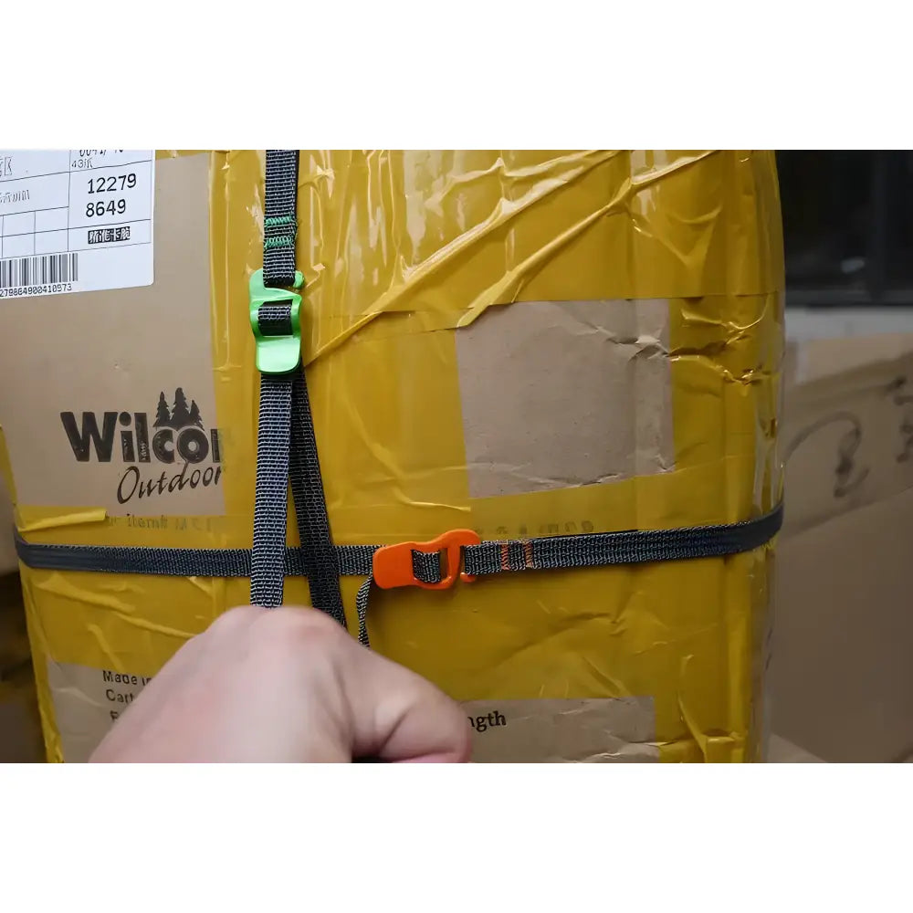 Yellow package or parcel secured with straps, labeled ’Wilson Outdoor’.