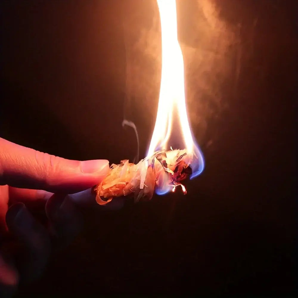 Burning marijuana joint held between fingers.