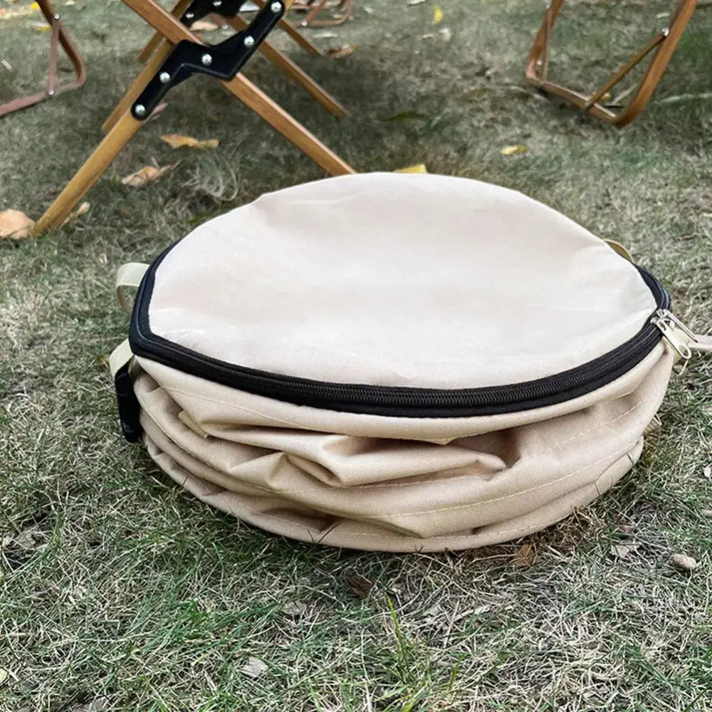 Circular beige fabric container with a zippered top.