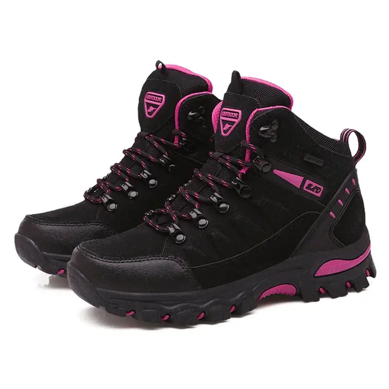 Pair of black and pink hiking boots with rugged soles.