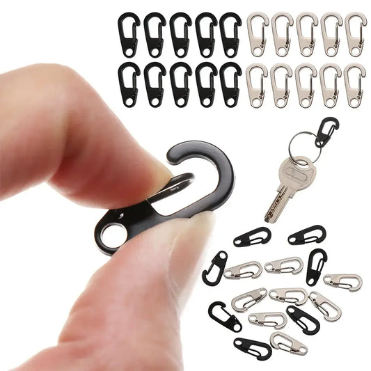 Carabiner-style clip being held between a thumb and forefinger.