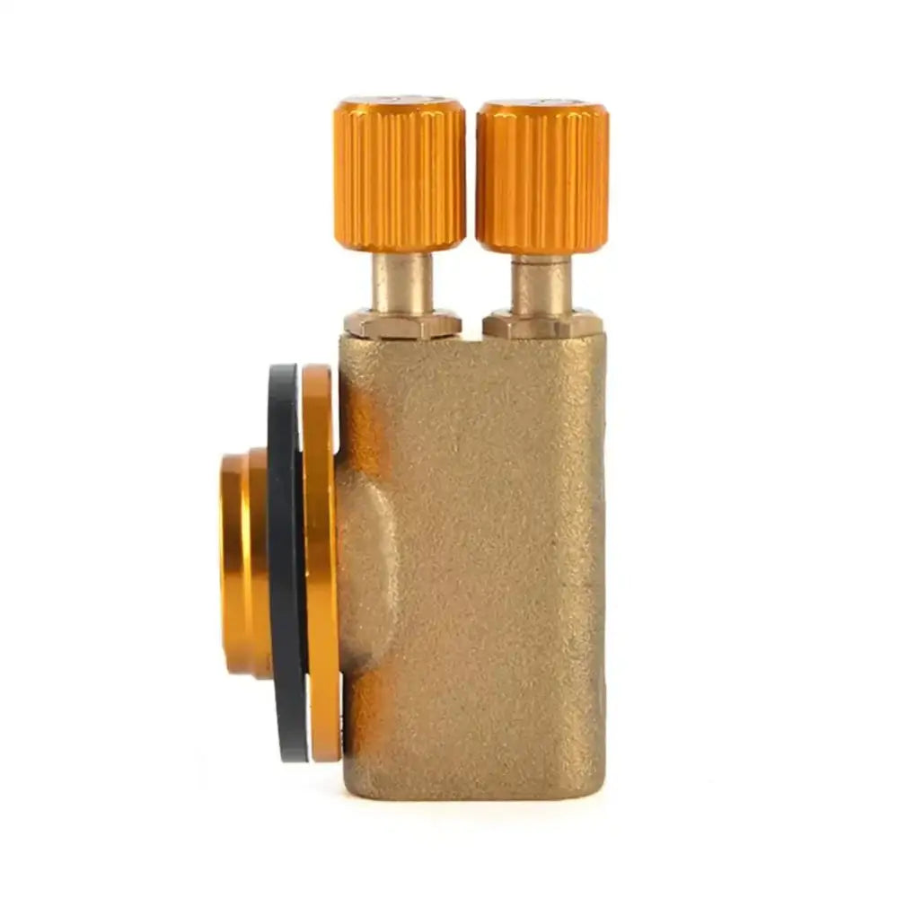 Brass valve or regulator with orange knobs and a gold-colored body.