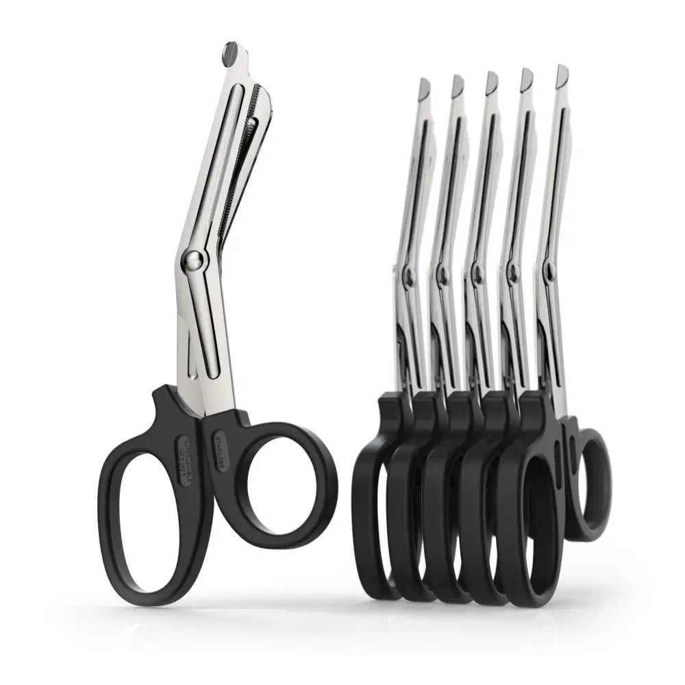 Set of stainless steel trauma shears or medical scissors with black handles.