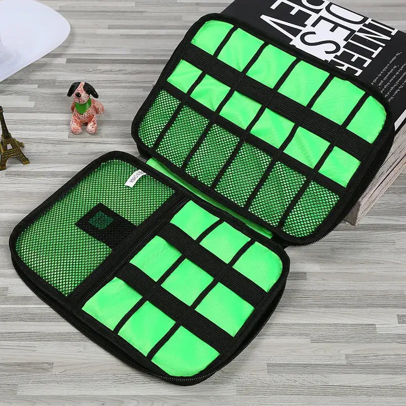 Cable organizer with bright green compartments for storing electronic accessories.