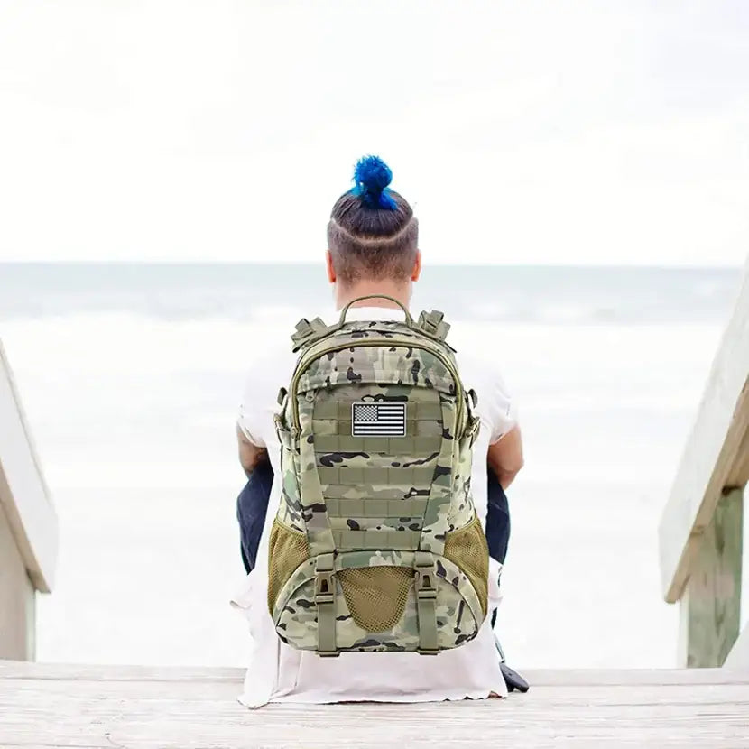 Military-style backpack with camouflage pattern and an American flag patch.