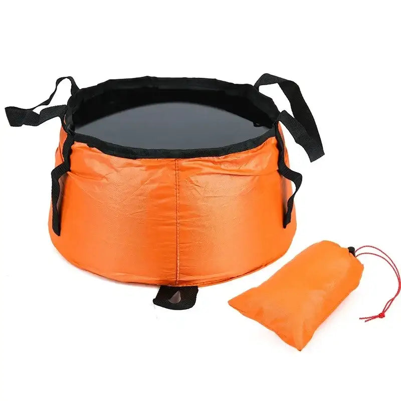 Collapsible orange and black camping sink or basin with a carrying pouch.