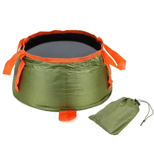 Collapsible outdoor basin or sink with orange trim and a matching storage bag.