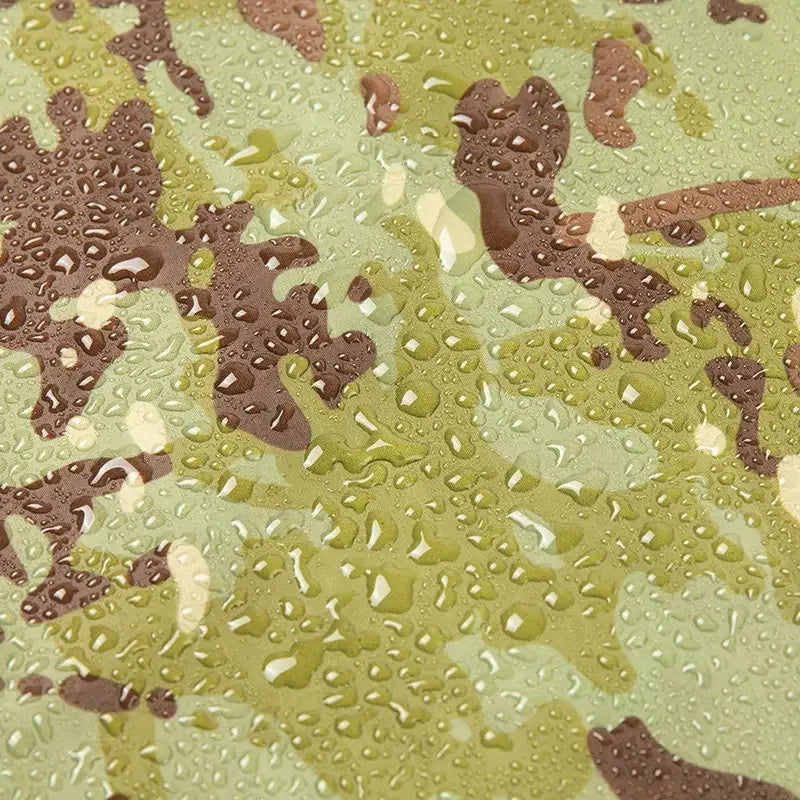 Camouflage pattern with water droplets on its surface.