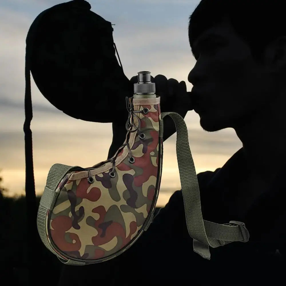 Camouflage-patterned canteen or water flask with a strap.