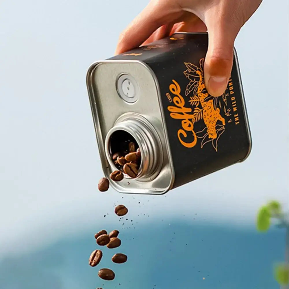 Coffee bean container designed to look like an oversized tin can with a spout for pouring.