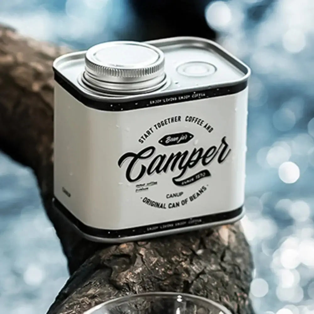 Square tin container labeled ’Camper’ in vintage-style lettering.