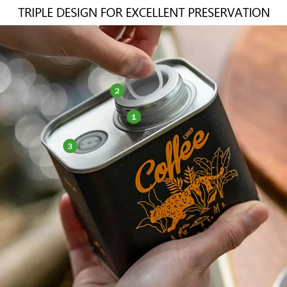 Coffee tin with a triple-seal lid design featuring a decorative black and orange label.