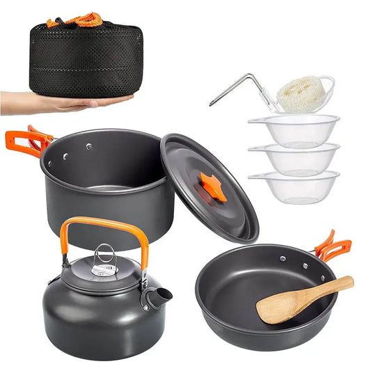 Camping cookware set including pots, pans, kettle, bowls, and utensils.