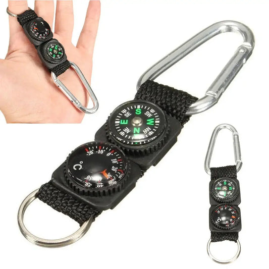 Carabiner keychain with two small compasses attached to a black fabric strap.