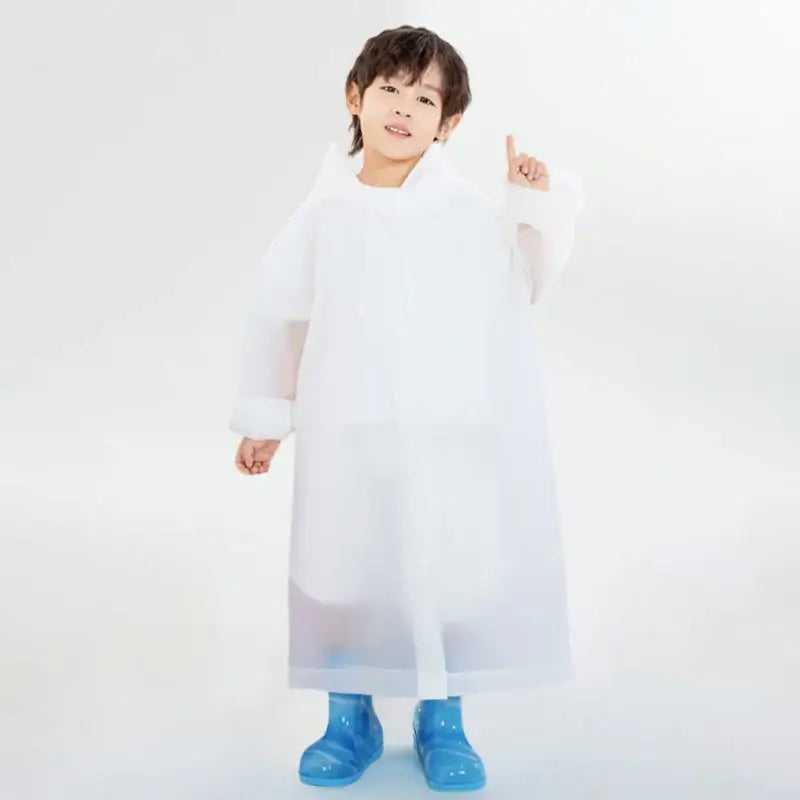 Child wearing a white smock and blue boots.