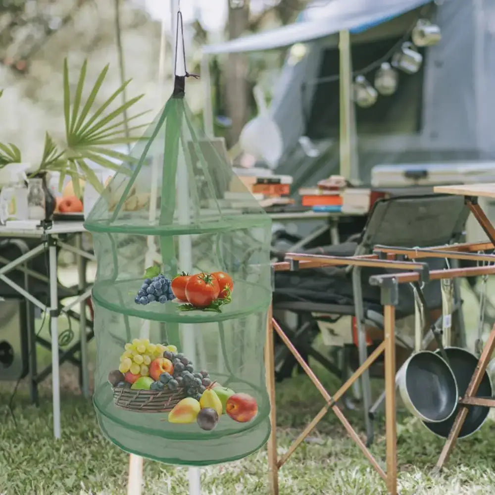 Hanging mesh food storage container with multiple tiers holding fruits and vegetables.