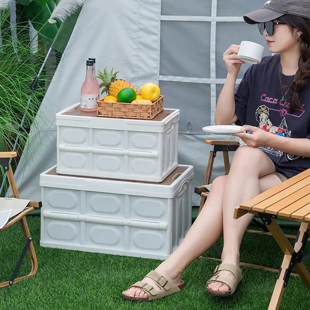 Woman sitting outdoors enjoying a drink and snack.