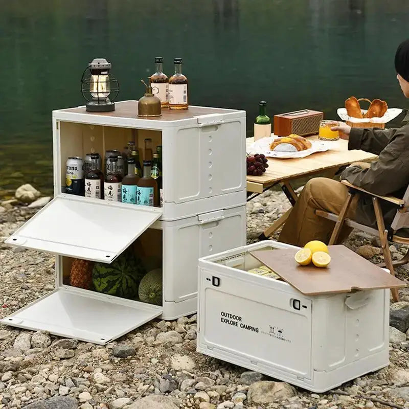 Portable modular camping kitchen with storage compartments and fold-out surfaces.