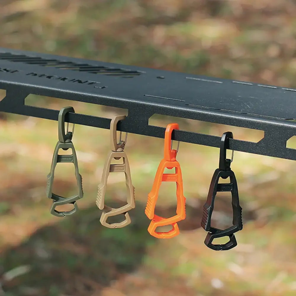 Carabiners in various colors hanging from a metal rail.