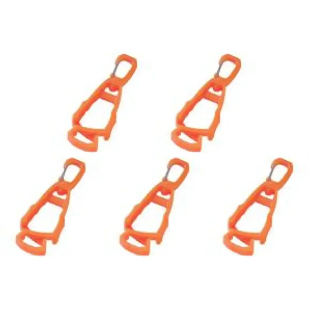 Orange plastic tent pegs or stakes arranged in a row.