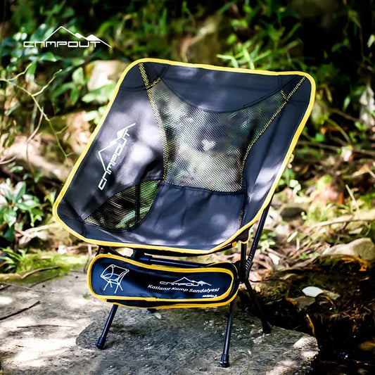 Compact folding camping chair with a black mesh seat and yellow trim.