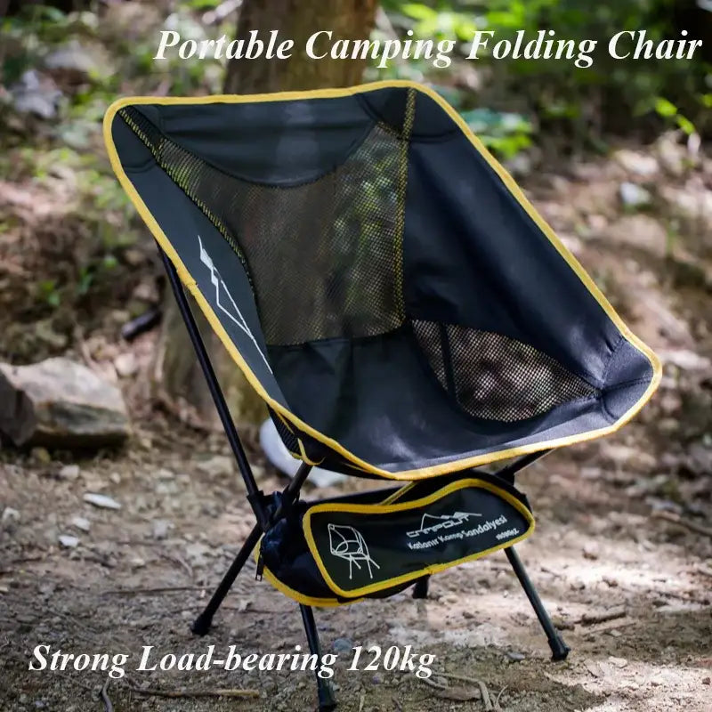 Portable camping folding chair with a black mesh seat and yellow trim.