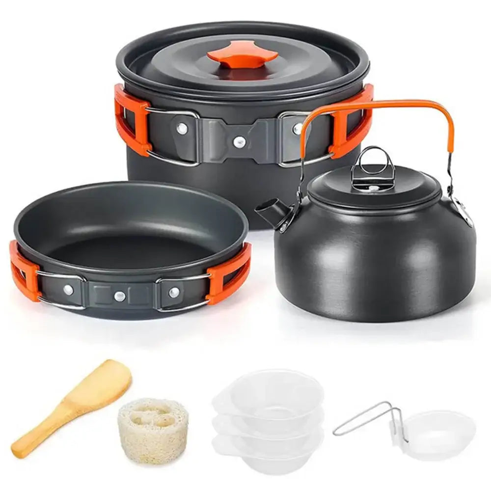 Camping cookware set featuring pots, pans, kettle, and utensils.