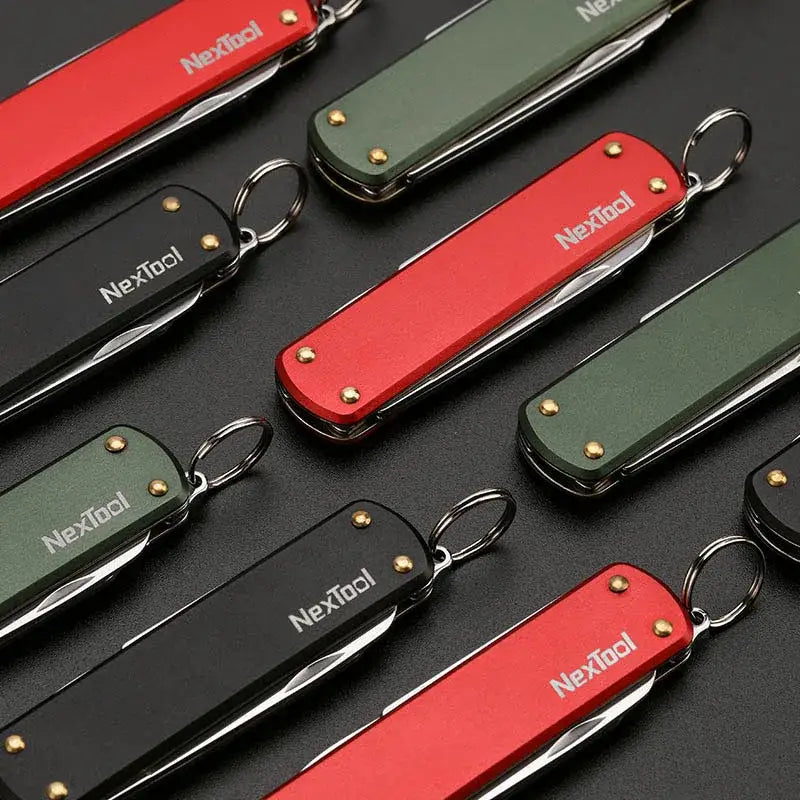 Multi-tool pocket knives in red and green colors with keyrings attached.