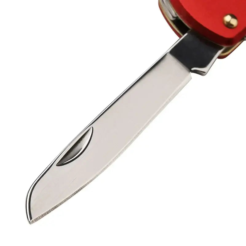 Stainless steel knife blade with a red handle partially visible.