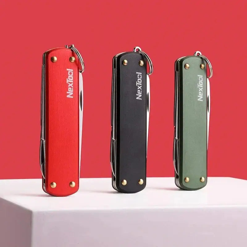 Three folding pocket knives in red, black, and green colors.