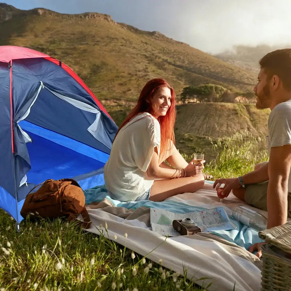 Colorful camping tent set up in a grassy outdoor area.