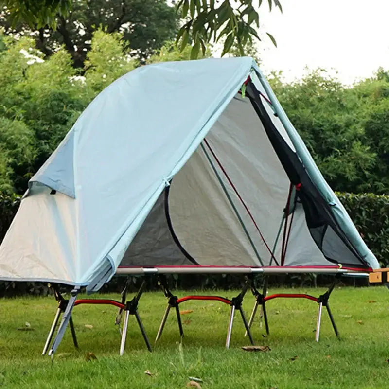 Tent elevated on a folding cot-like frame with legs.