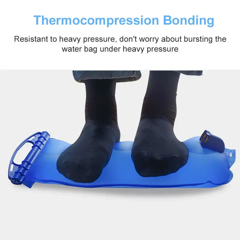 Blue inflatable water bag or cushion with two black-socked feet resting on it.