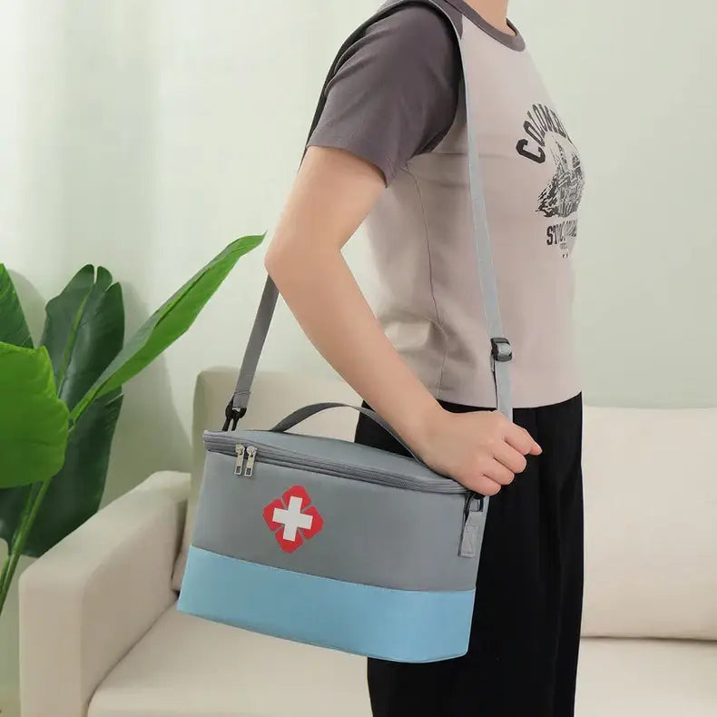 First aid kit bag with a red cross symbol and blue accent stripe.