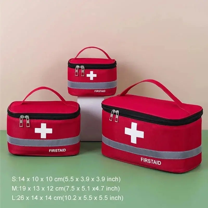 First aid kits in red bags with white cross symbols and carrying handles.