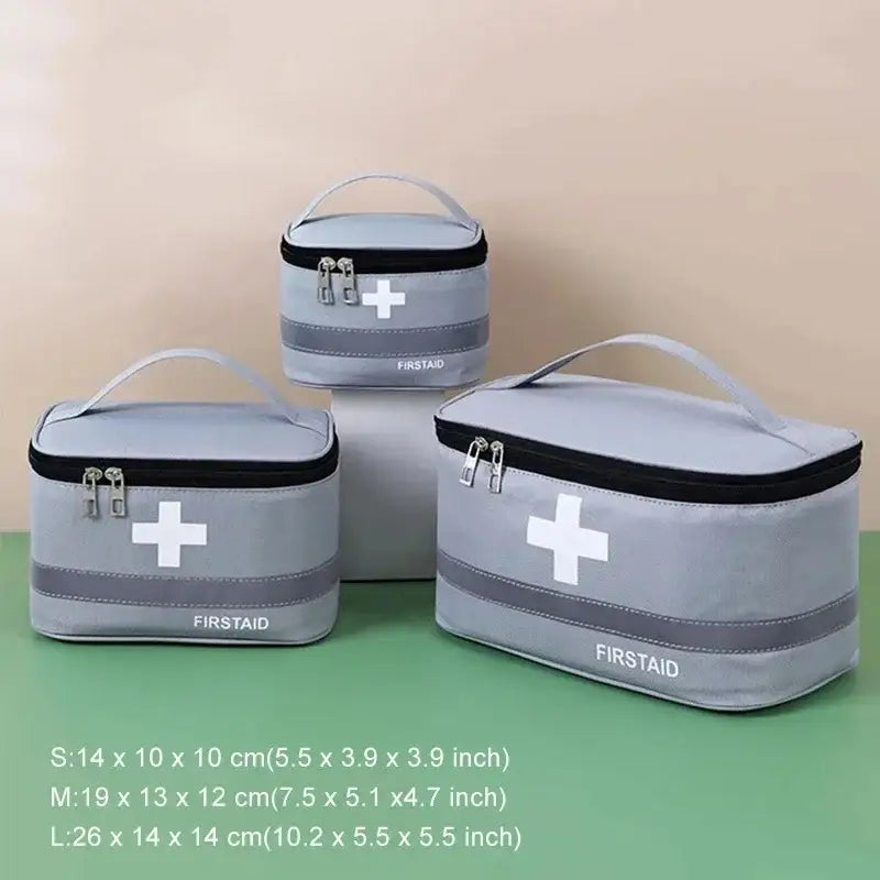 First aid kits in gray zippered cases with white cross symbols.