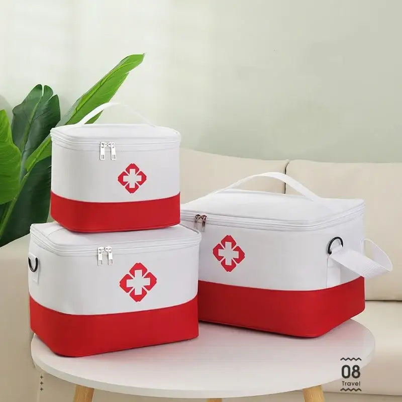 Set of three white and red medical storage bags with cross symbols.