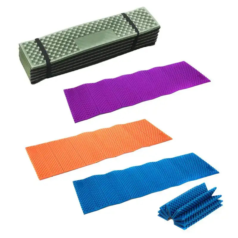 Folding camping or outdoor sleeping mats in various colors.