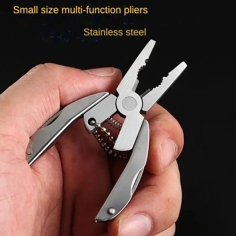 Stainless steel multi-function pliers with folding tools held in a hand.