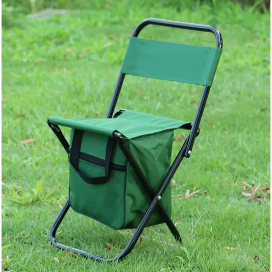 Folding green camping chair with attached storage bag.