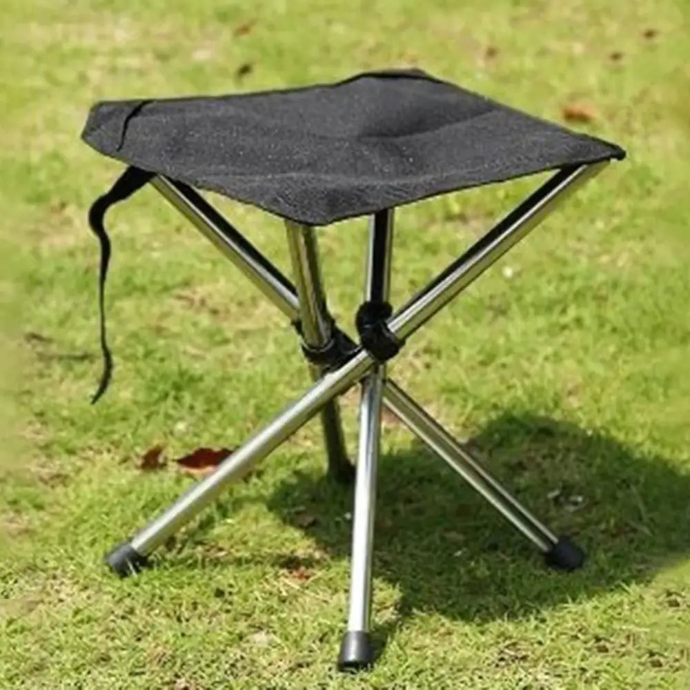 Portable folding stool with a black fabric seat and metal legs.