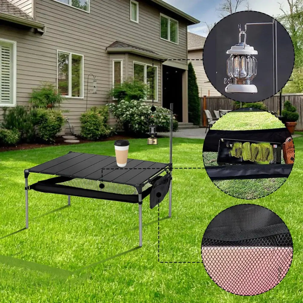 Portable folding camping table with a black mesh surface and metal frame.