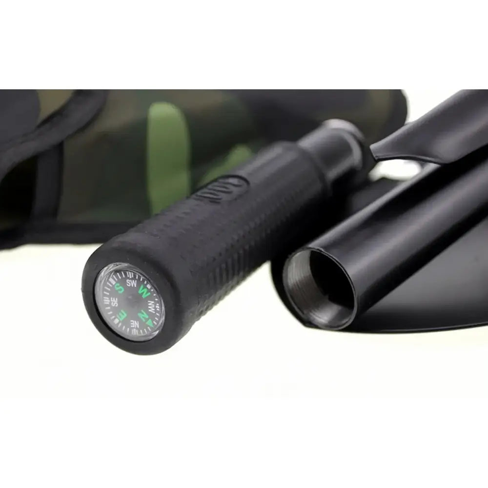 Black tactical flashlight with a built-in compass on the end.