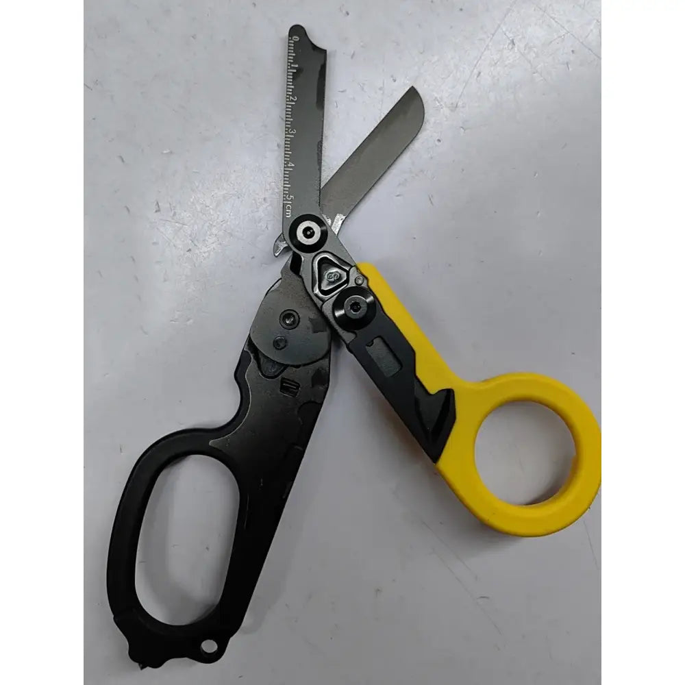 Multitool combining scissors with a yellow handle and a black utility tool attachment.