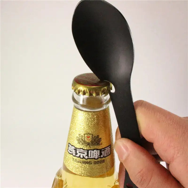 Plastic spoon-shaped bottle opener designed to fit over a beer bottle cap.