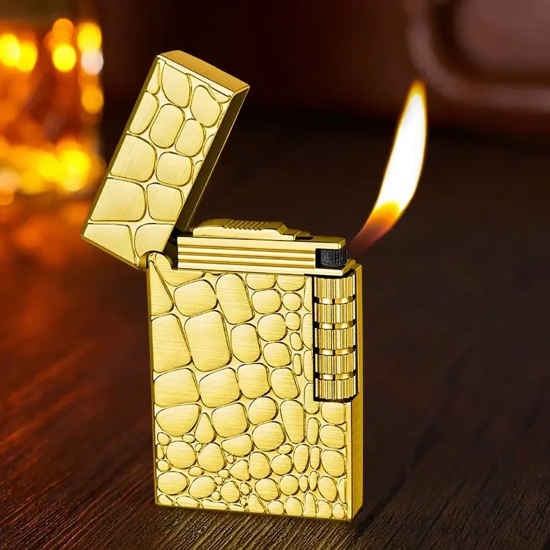 Gold-colored luxury lighter with a crocodile skin pattern design.