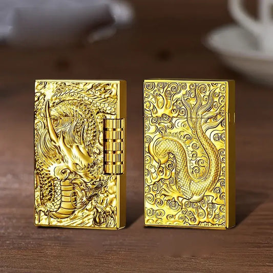 Two ornate gold-colored metal lighters with intricate dragon designs engraved on their surfaces.