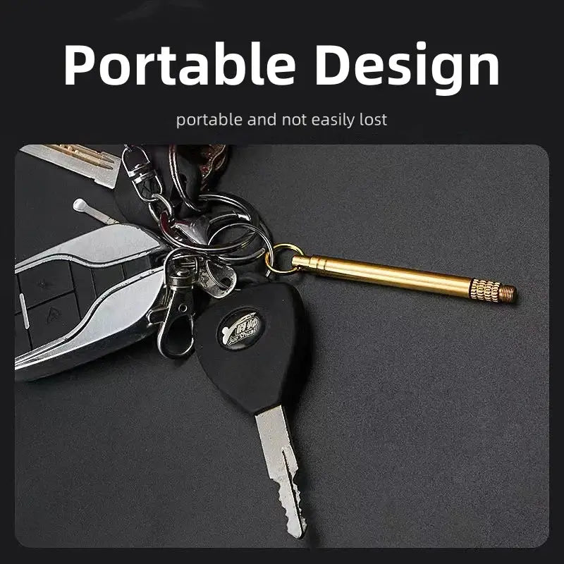 Keychain with a brass pen or stylus attached to a set of keys.