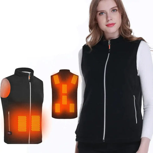 Heated black vest with orange glowing panels worn by a woman.