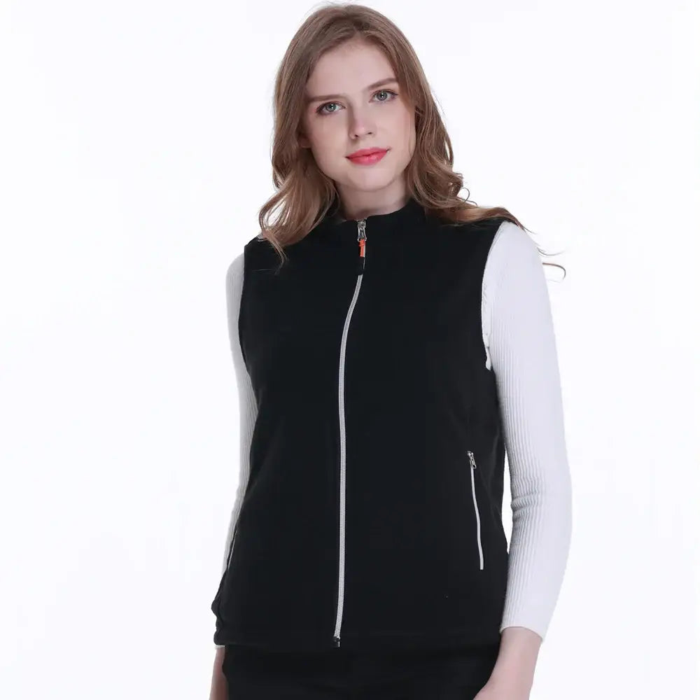 Black zippered vest worn over a white long-sleeved top.